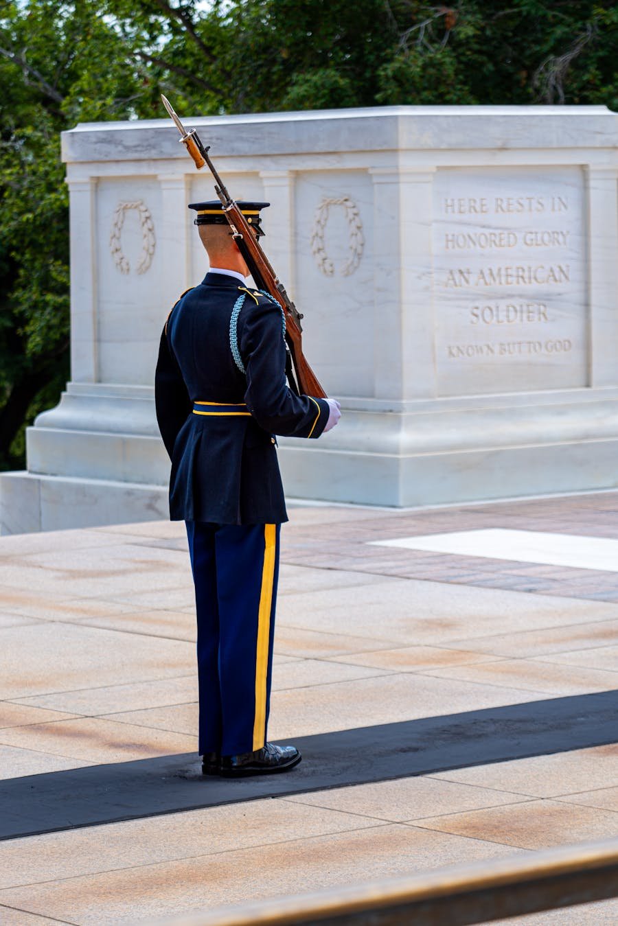 Solemn military honor guard at a memorial site.