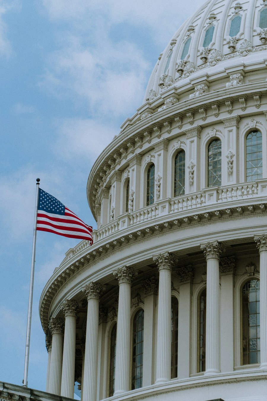 US Capitol dome with American flag.