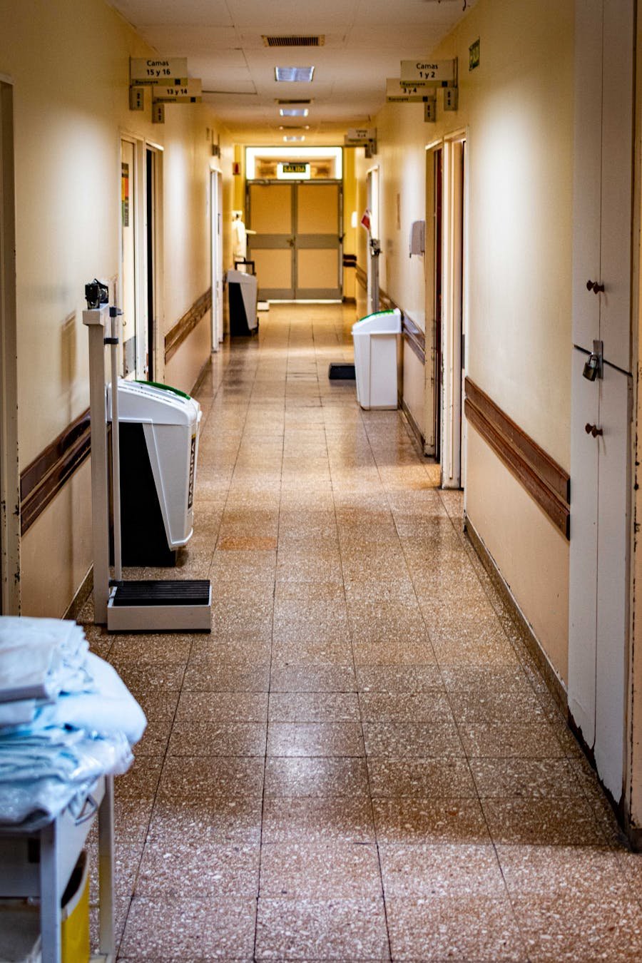 Empty hospital corridor with medical equipment.